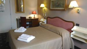 Postel nebo postele na pokoji v ubytování Holiday Rooms Antica Badia