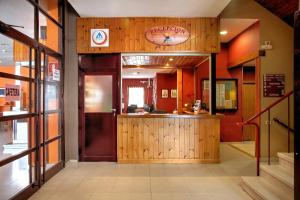 a restaurant with a bar in the middle of a building at Albergue Era Garona in Salardú