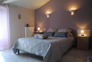 a bedroom with a bed with two pillows on it at La Poussardiere in Saint-Martin-sous-Mouzeuil