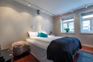 a bedroom with a large bed and two windows at Enter Viking Hotel in Tromsø