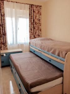 a bedroom with two beds and a window at LAS PERLAS - 1º Linea in Denia