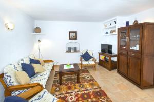 a living room with a couch and a table at Owl Booking Villa Bennasar - Rustic Stay in Pollença