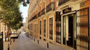 هوستلز ميتنجبوينت في مدريد: شارع فيه سيارة متوقفة على جانب مبنى