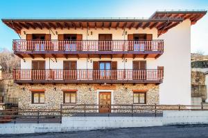 a building with a balcony on top of it at Ginepro d'Abruzzo in Casamaina