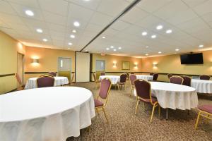 a conference room with tables and chairs and a tv at Baymont by Wyndham Culpeper in Culpeper