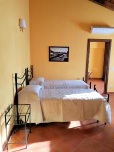 a bedroom with a large bed with a glass table at Corte Certosina in Trezzano sul Naviglio