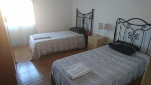 Ліжко або ліжка в номері Apartment Palmar I 50 por ciento dscto direco