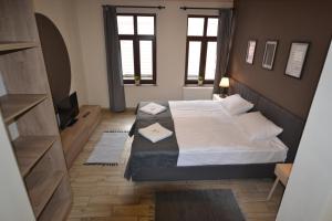 a bedroom with two beds and a flat screen tv at SleepWell Apartments in Legnica