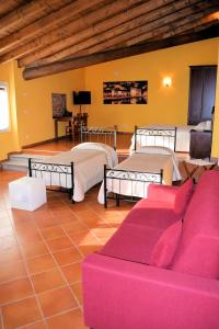 a living room with two beds and a couch at Corte Certosina in Trezzano sul Naviglio