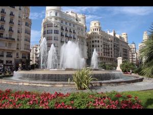 a fountain in the middle of a city with buildings at Apartment Sofi in Valencia