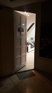 an open door to a room with an open refrigerator at Főnix de Lux Apartman in Debrecen