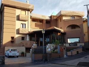 a building with a car parked in front of it at Hotel Santa Caterina in Fisciano