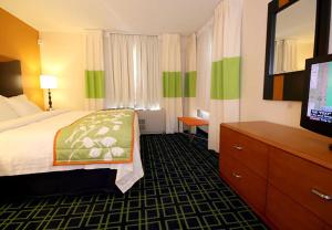 a hotel room with a bed and a television at Fairfield Inn and Suites White River Junction in White River Junction