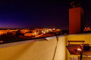 a view of a city at night from a balcony at Venceslau Boutique in Vila do Conde
