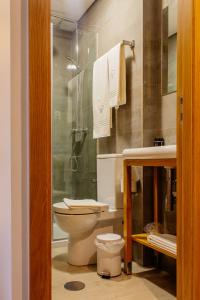 a bathroom with a toilet and a shower and a sink at Venceslau Wine Boutique Hostel in Vila do Conde