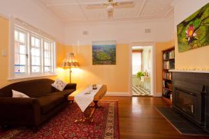 a living room with a couch and a fireplace at Taree Apartment in Taree