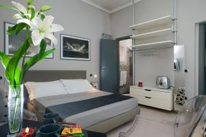 a bedroom with a bed and a vase with a flower at B&B Best Vatican in Rome