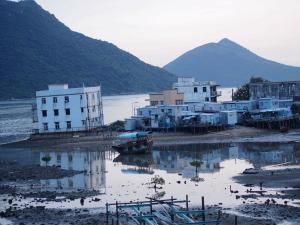 a group of buildings next to a body of water at Tai O Inn, by the Sea in Hong Kong