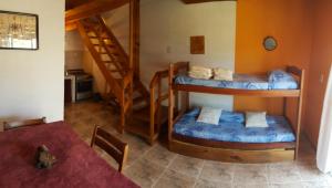 a room with two bunk beds and a table at La Rosarita Club in Santa Teresita
