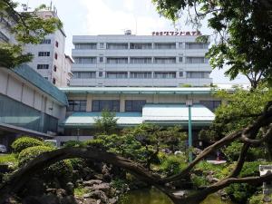 a building with a garden in front of it at Ikaho Grand Hotel in Shibukawa