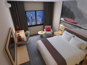 TaixingにあるThank Inn Plus Hotel Jiangsu Taizhou Venice Cityの大きなベッドと大きな窓が備わるホテルルームです。