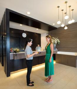 a man and a woman standing in a kitchen at Simplitel in Karon Beach +37 photos