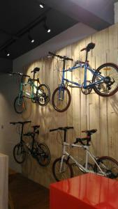 three bikes are hanging on a wall at REST backpacker in Tainan