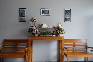 a dining room table with two chairs and flowers on it at The Besavana Phuket - SHA Extra Plus in Phuket Town
