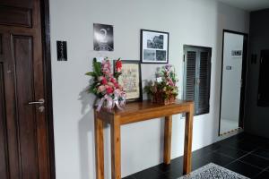 a room with a table with flowers and a mirror at The Besavana Phuket - SHA Extra Plus in Phuket Town