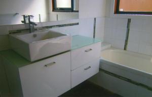 a bathroom with a sink and a bath tub at Bay Breeze Beach Holiday Home in Corinella