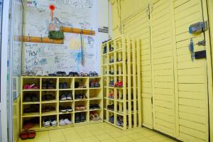 a room with some shelves with shoes in it at Topchan in Tashkent