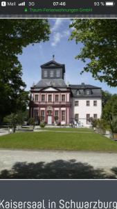 a large red and white house with a tree at Ferienwohnung Dietlinde in Bad Blankenburg +30 photos