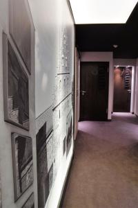 a hallway with pictures on the wall of a building at Ebracher Hof in Schweinfurt