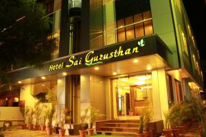 a building with a sign that reads hotel sat guatemalan at Hotel Sai Gurusthan in Shirdi