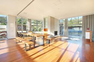 a large living room with a table and chairs at Glen Sunsets Villa by Totalstay in Cape Town