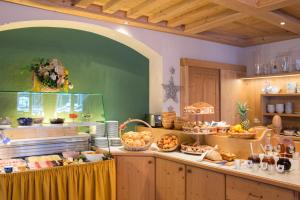 a kitchen with a counter with a lot of food at Hotel-Appartement Ferienhof in Gerlos