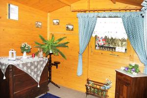 a wooden room with a table and a window at Landpension Zum Schweizerberg in Neugrimnitz
