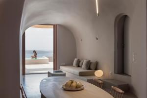 a living room with a table and a couch at Aesthesis Boutique Villas Firostefani in Firostefani