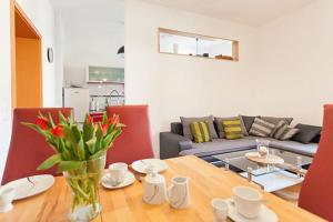 a dining room table with a vase of flowers on it at Ferienwohnung City in Erfurt
