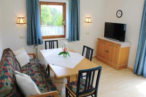 a living room with a couch and a table at Am Zanggerhof in Imst