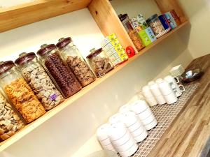 a organized pantry with jars of food and drinks at Belfast House in Cookstown
