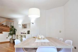 a dining room with a table and white chairs at SERINAMAR- Los Naranjos de Marbella in Marbella +36 photos