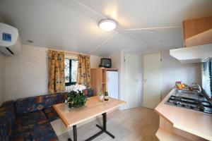 a living room with a couch and a table at Camping C'era Una Volta in Villanova dʼAlbenga