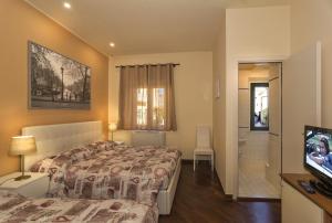 Posteľ alebo postele v izbe v ubytovaní Hotel Il Giardino