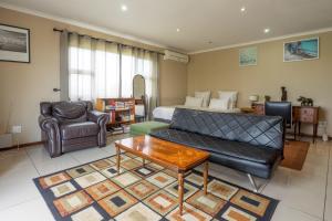 a living room with a couch and a table at Carrington Guest House in Durban