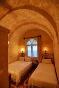 two beds in a room with a window at Hotel Surban - Special Category in Urgup