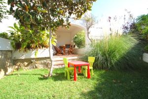 a table and chairs in a yard with a patio at ARENDA Pino Alto Holiday Home Martin 18 in Miami Platja +26 photos