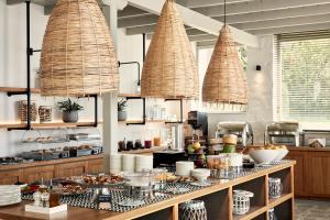 a kitchen with a buffet of food on display at Poseidon of Paros Hotel & Spa in Chrissi Akti