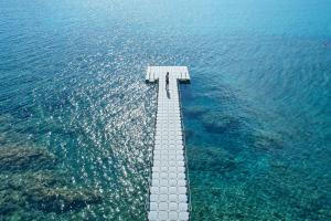 an aerial view of a pier in the water at Poseidon of Paros Hotel & Spa in Chrissi Akti
