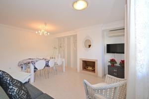 a dining room and living room with a table and chairs at Salada House in Port d'Alcudia